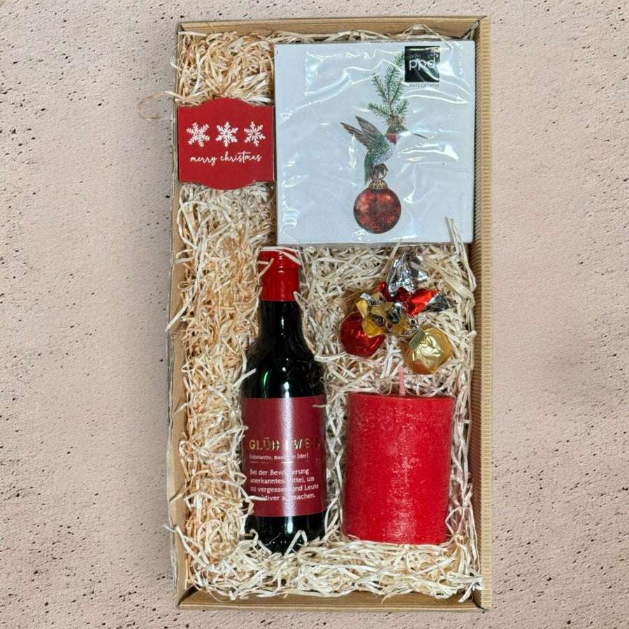 Glühwein Geschenkset mit Grafik Werkstatt Glühwein Venchi Schokolade roter Wachskerze Pflanztöpfchen Tannengrüße und Franklin Servietten in Geschenkverpackung